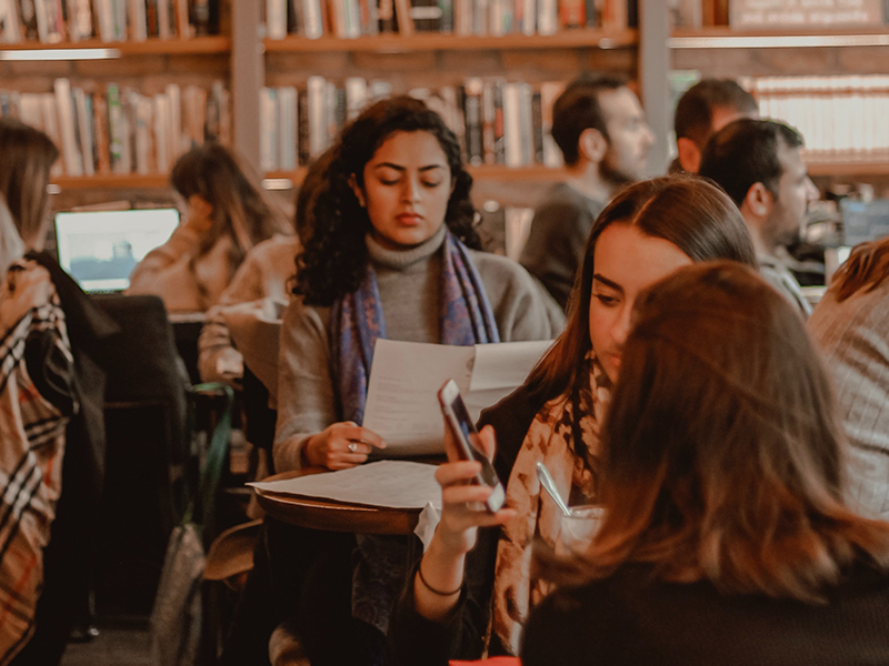 Who-We-Are Decorative Image focuses on person reading in a library